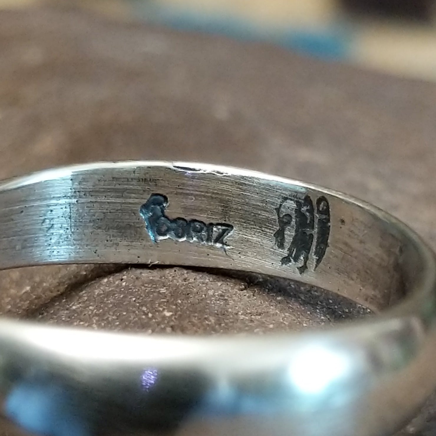Close-up of the artisan's stamped signature.