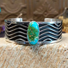 Sterling silver cuff with Sonoran gold turquoise set in an oval bezel and wavey silverwork along the band.