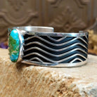 Sterling silver cuff with Sonoran gold turquoise set in an oval bezel and wavey silverwork along the band.