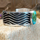 Sterling silver cuff with Sonoran gold turquoise set in an oval bezel and wavey silverwork along the band.