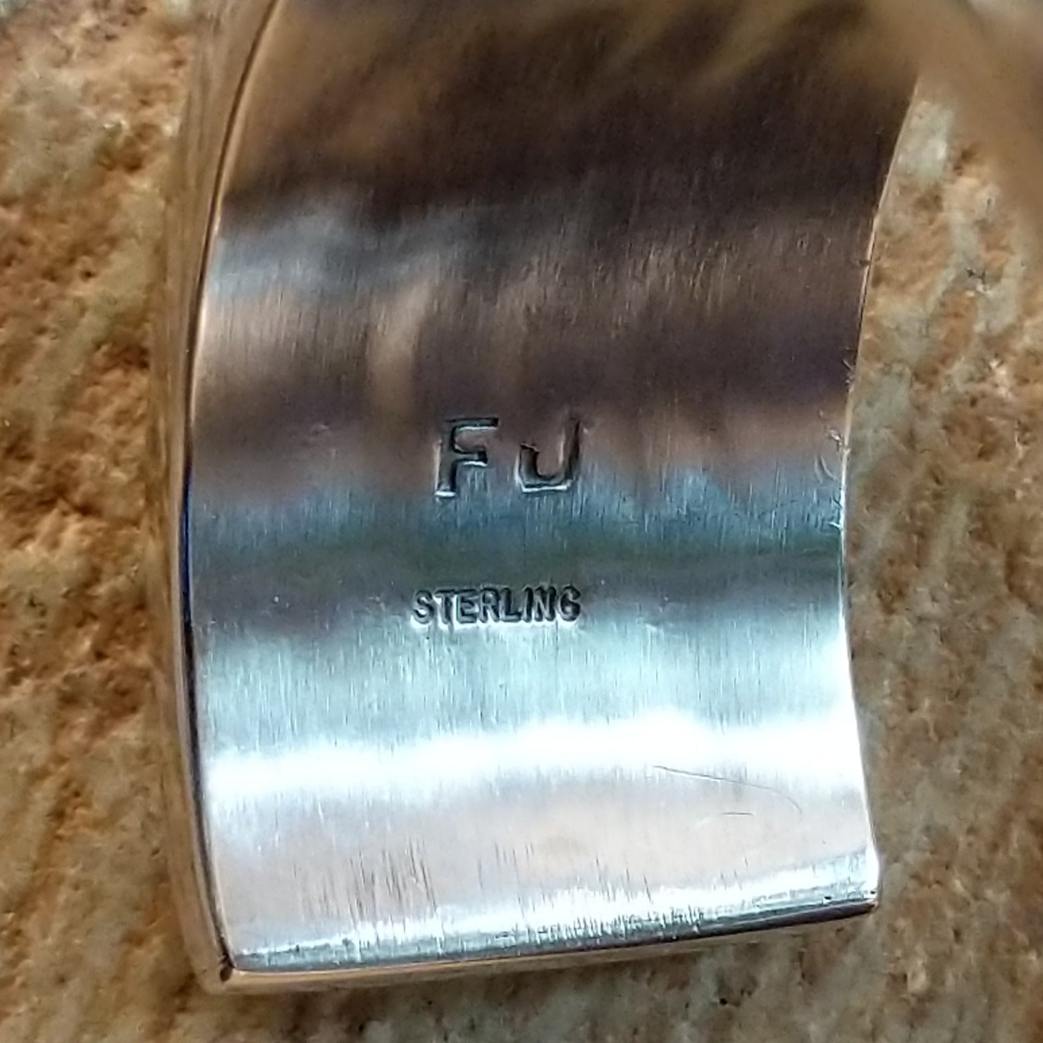 Close-up of the artisan's stamped signature.