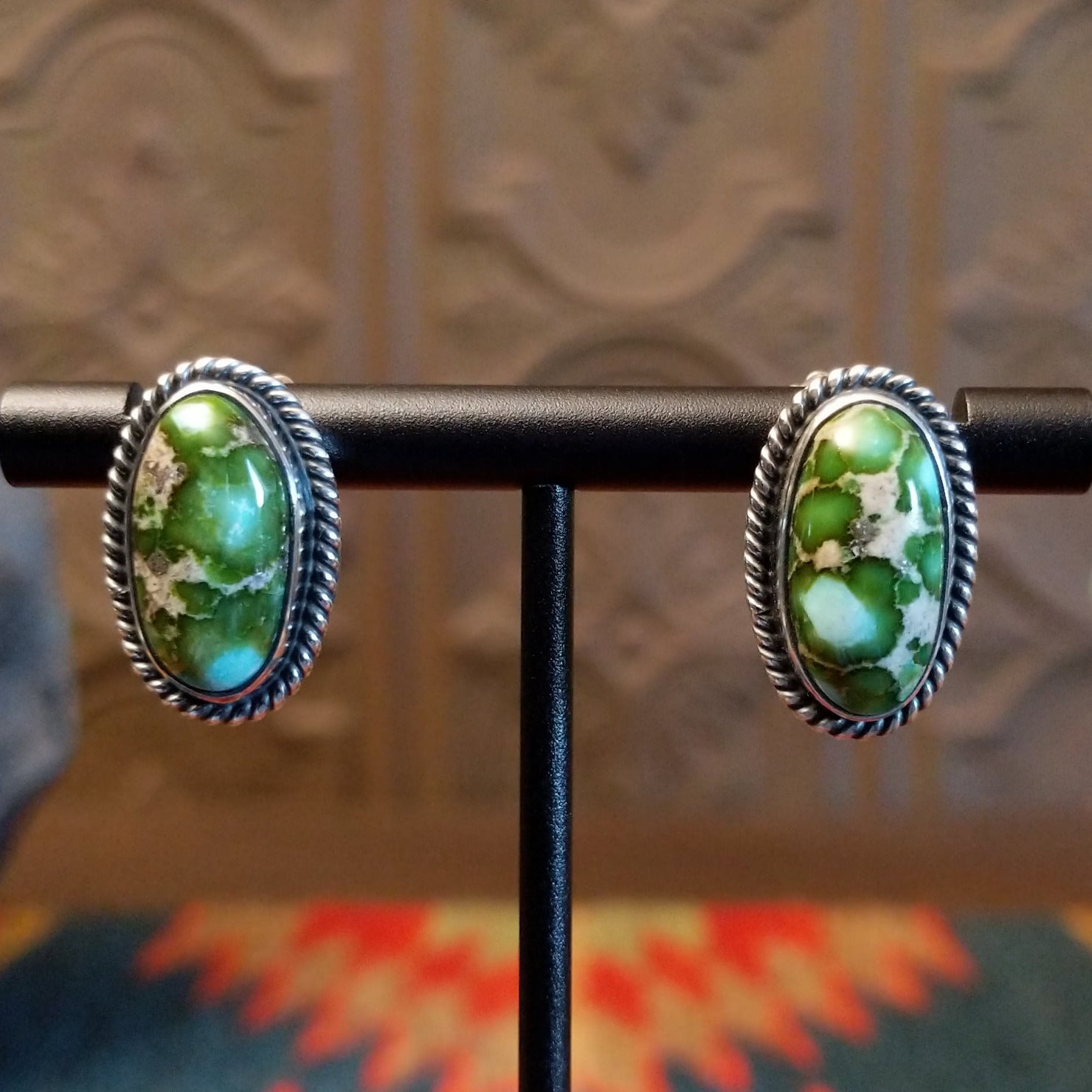 Sterling silver earrings with sonoran gold turquoise set in oval bezels, framed by twisted rope accents.