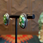 Sterling silver earrings with sonoran gold turquoise set in oval bezels, framed by twisted rope accents.