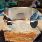 Sonoran Gold turquoise feather cuff by Angela Martin, featuring a vibrant turquoise stone, detailed feather design, and handcrafted Southwestern-inspired metalwork.  Underside view.