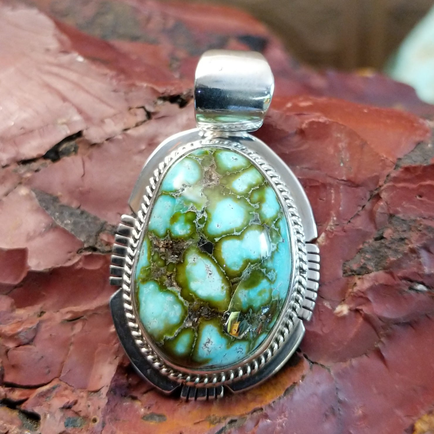 Sterling silver pendant with sonoran gold turquoise framed by twisted rope and stamped accents.