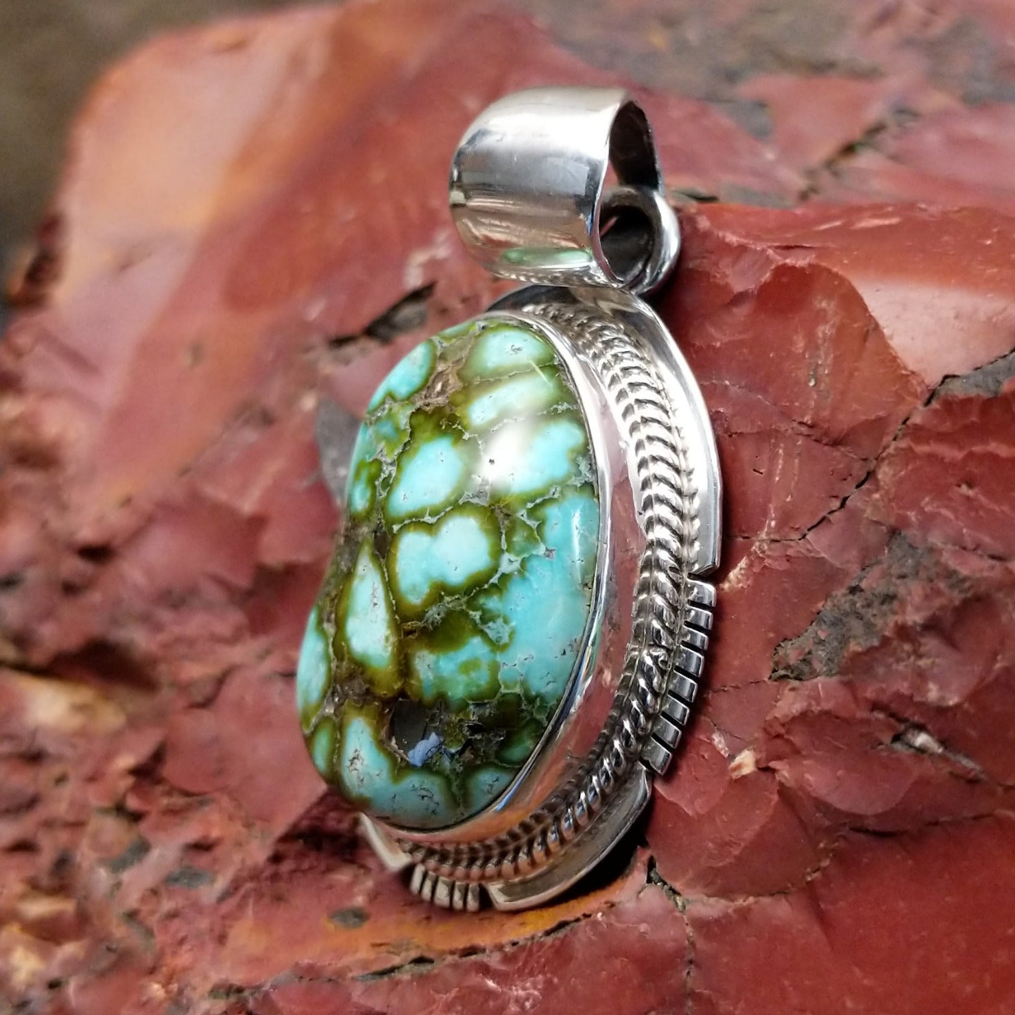 Sterling silver pendant with sonoran gold turquoise framed by twisted rope and stamped accents.