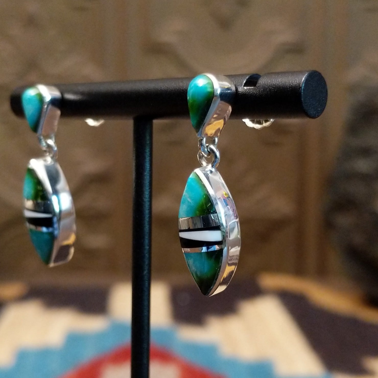 Sterling silver drop earrings with a multistone inlay. 