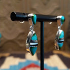 Sterling silver drop earrings with a multistone inlay. 