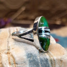 Sterling silver ring with multistone inlay set in an oval bezel.