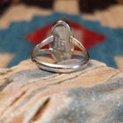 Sterling silver ring with multistone inlay set in an oval bezel.