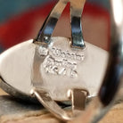 Close-up of the artisan's stamped signature.