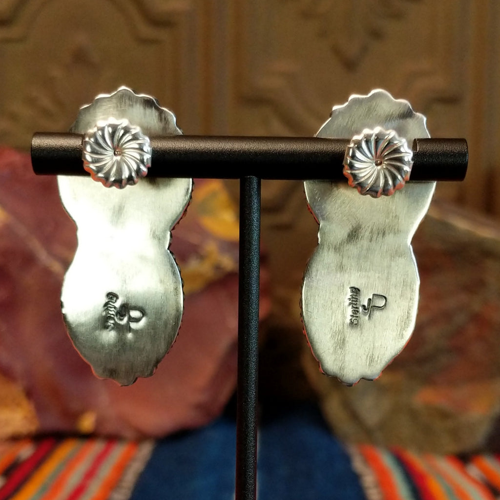 The sterling silver stud backings of the drop earrings and artisan's initials stamped.