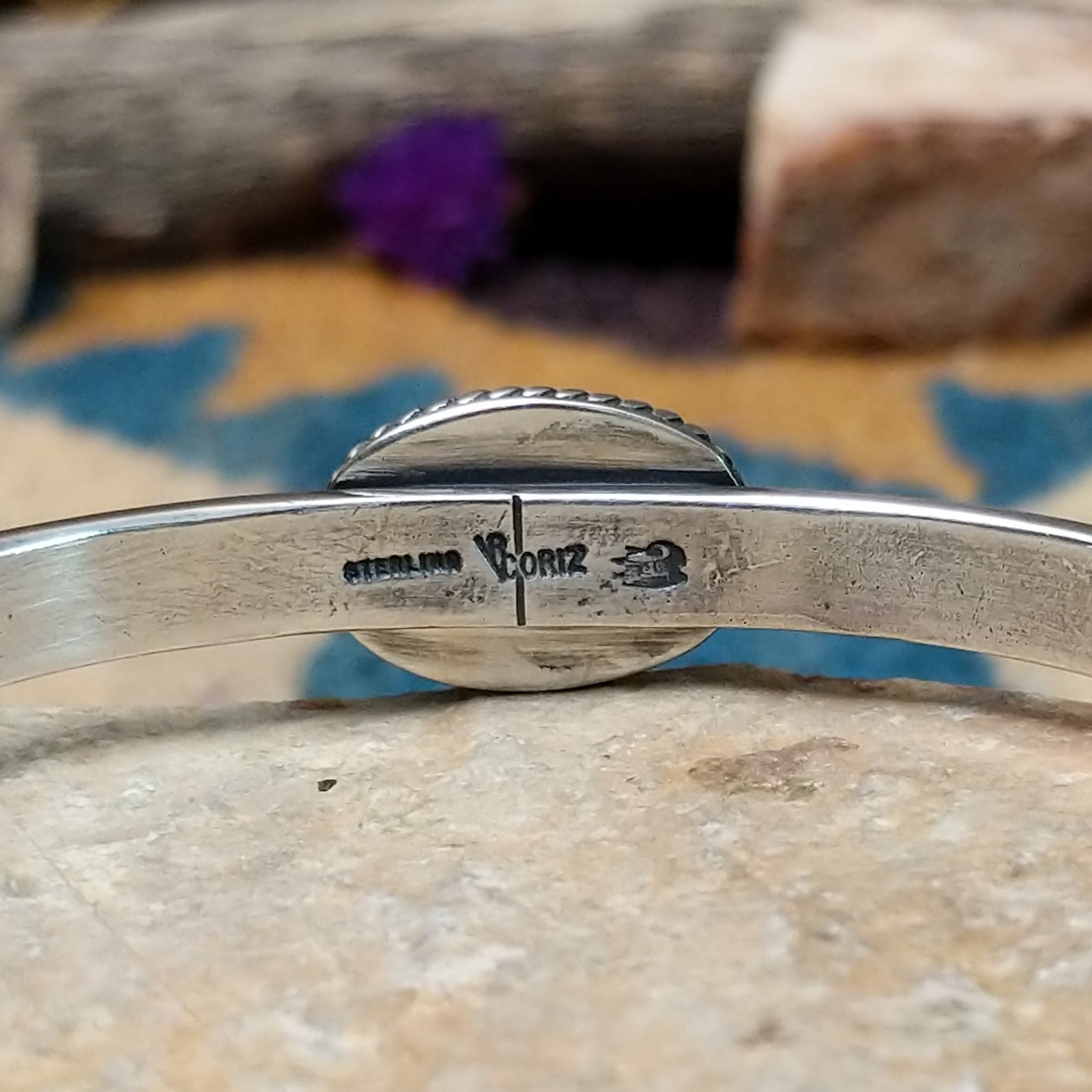 Handcrafted sterling silver cuff by Raymond Coriz featuring an oval Sonoran Gold turquoise cabochon in a twisted rope bezel on a three-wire cuff with hand-stamped fan accents; artisan and Sterling Silver stamp.