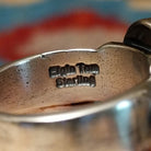 Close-up of the artisan's stamped signature.