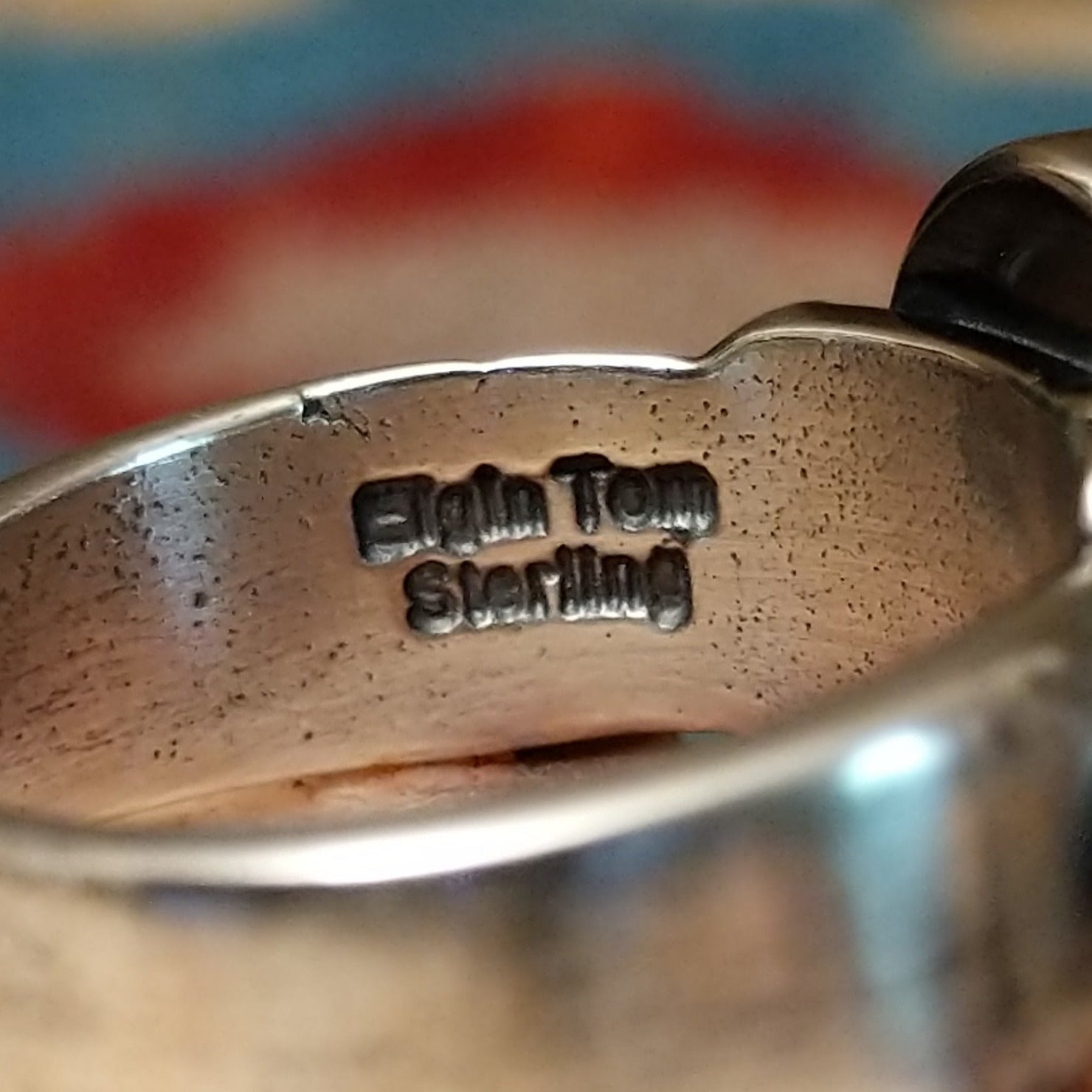 Close-up of the artisan's stamped signature.