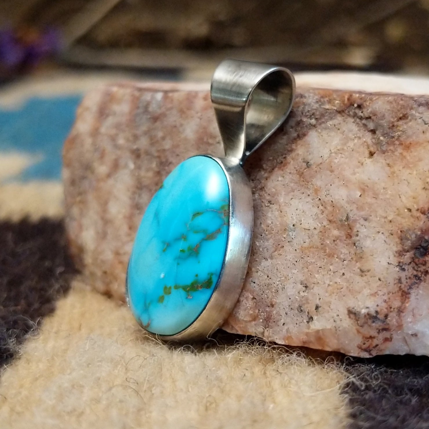 Sterling silver pendant with Sonoran gold turquoise set in an ovate bezel.