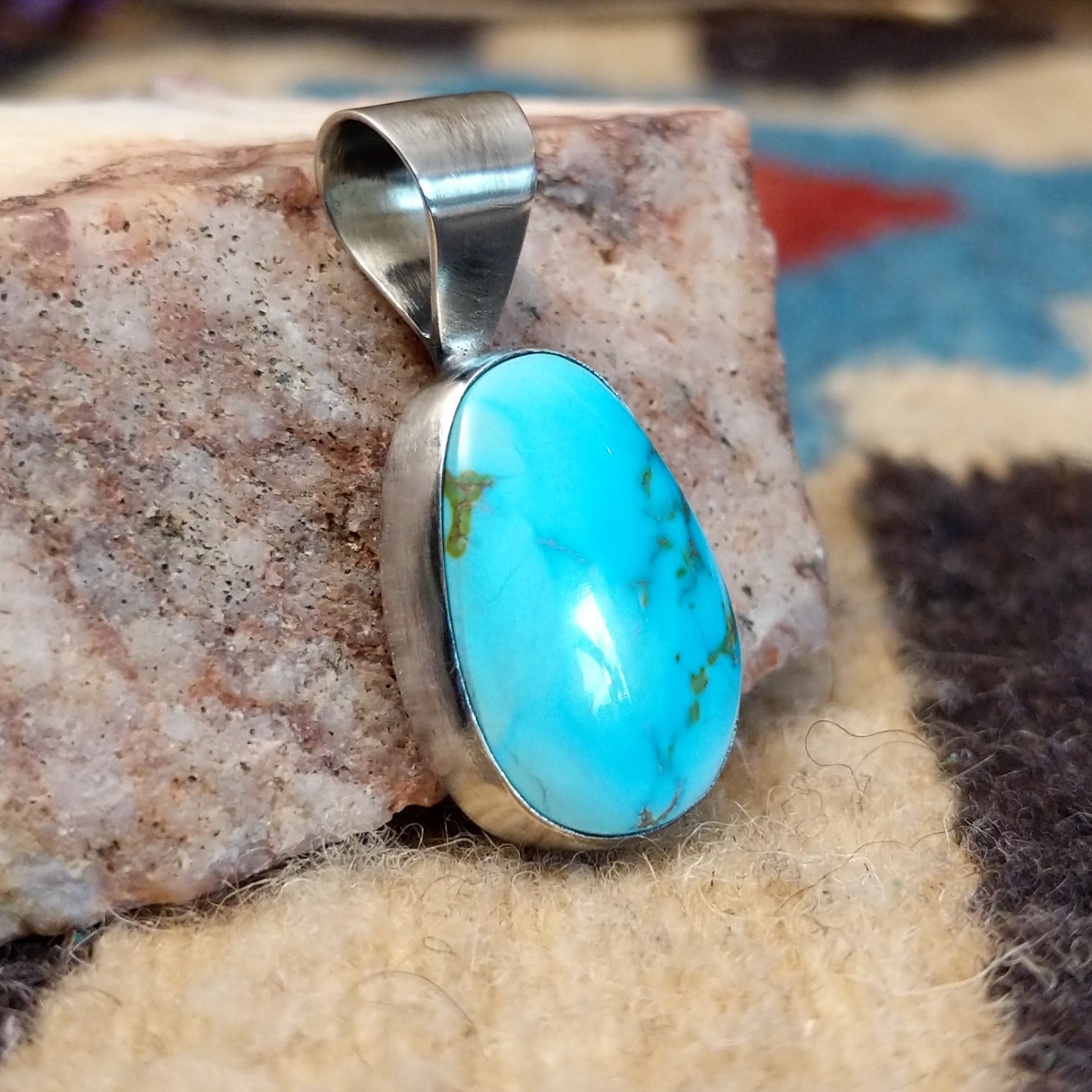 Sterling silver pendant with Sonoran gold turquoise set in an ovate bezel.