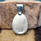 Close-up of the artisan's stamped signature.