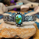 Handcrafted Navajo sterling silver cuff by Michael Thompson featuring an oval Sonoran Gold turquoise cabochon with a rope bezel, silver bead accents, and a hand-stamped geometric cuff band.