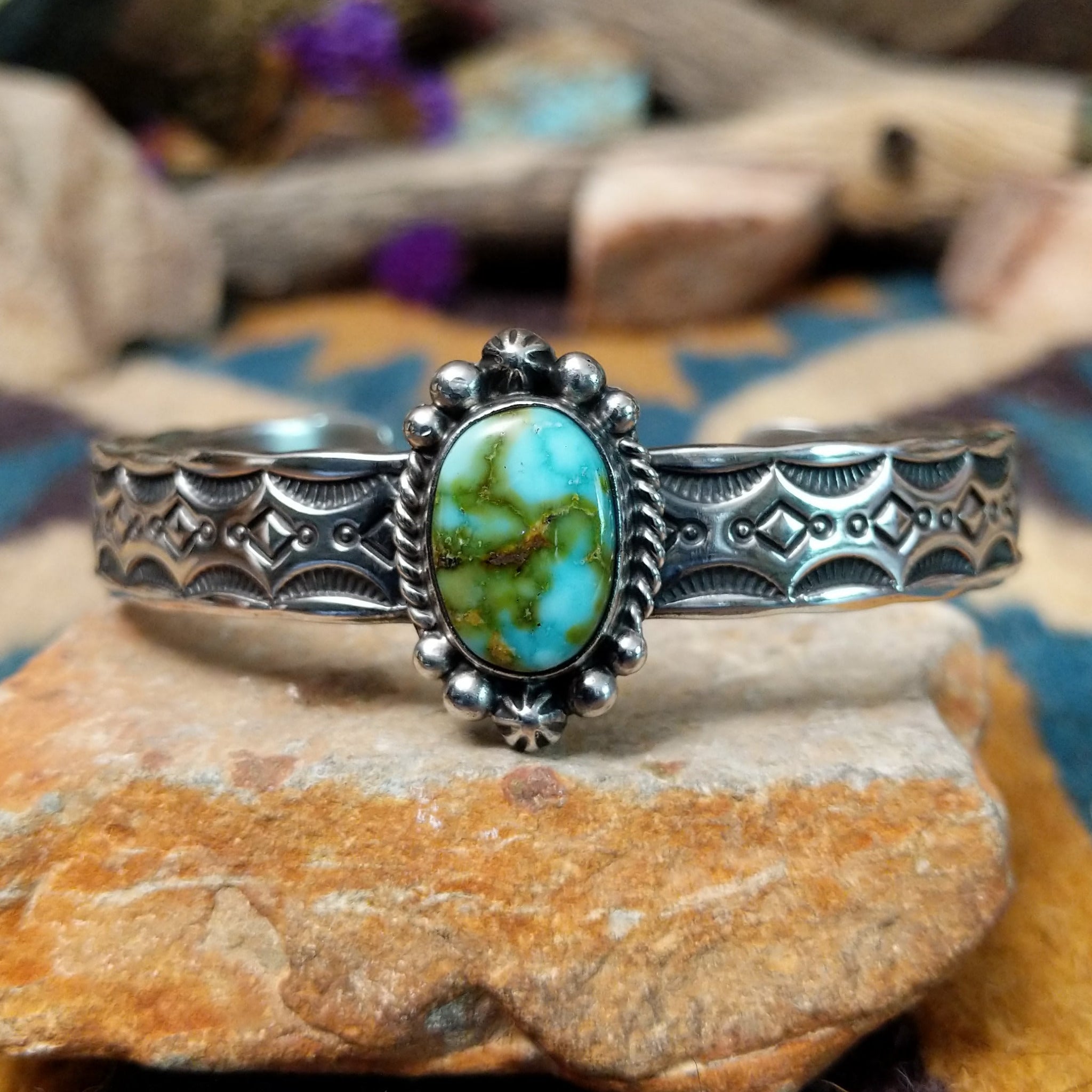 Handcrafted Navajo sterling silver cuff by Michael Thompson featuring an oval Sonoran Gold turquoise cabochon with a rope bezel, silver bead accents, and a hand-stamped geometric cuff band.