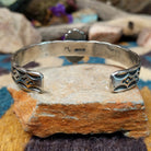 Handcrafted Navajo sterling silver cuff by Michael Thompson featuring an oval Sonoran Gold turquoise cabochon with a rope bezel, silver bead accents, and a hand-stamped geometric cuff band; underside view.