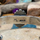 Handcrafted Navajo sterling silver cuff by Michael Thompson featuring an oval Sonoran Gold turquoise cabochon with a rope bezel, silver bead accents, and a hand-stamped geometric cuff band; artisan and Sterling Silver stamp.