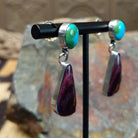 Handcrafted sterling silver Sonoran Gold turquoise and purple spiny oyster earrings by Lucy Jake, featuring a two-stone dangle design; side view.