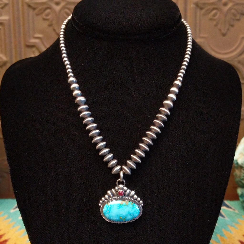 Sonoran Gold Turquoise and purple spiny oyster shell set in intricate setting with twisted rope accent and beaded sterling silver chain.