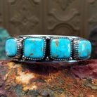 Sterling silver cuff featuring Sonoran gold turquoise set in square, etched bezels. 