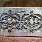Close-up of the artist's stamped signature.