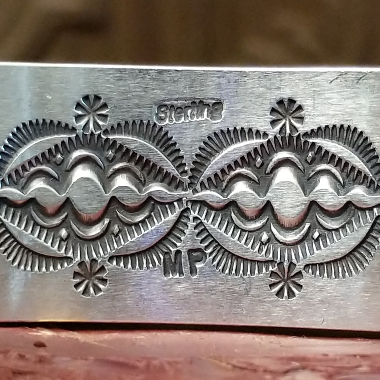 Close-up of the artist's stamped signature.