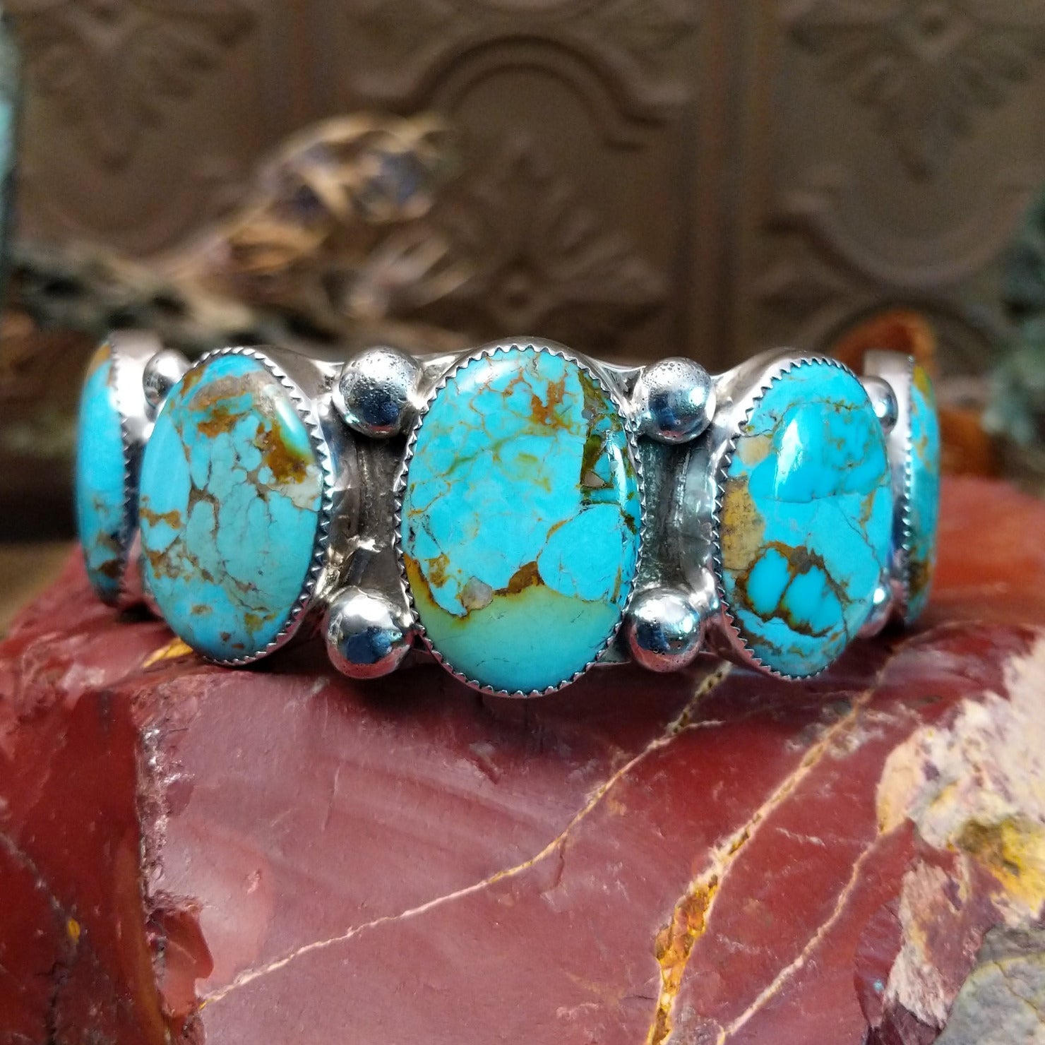 Sterling silver cuff bracelet with Sonoran gold turquoise set in notched, oval bezels. 