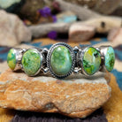 Handcrafted Navajo sterling silver cuff by Roie Jaque featuring five Sonoran Gold turquoise cabochons, including a rope-bordered center stone accented with polished silver bead details.