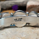 Handcrafted Navajo sterling silver cuff by Roie Jaque featuring five Sonoran Gold turquoise cabochons, including a rope-bordered center stone accented with polished silver bead details; artisan and Sterling Silver stamp.