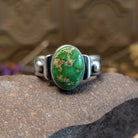 Sterling silver ring with Sonoran gold turquoise set in a raised, oval bezel and brushed finish.
