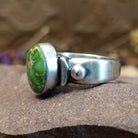 Sterling silver ring with Sonoran gold turquoise set in a raised, oval bezel and brushed finish.