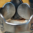 This captivating Sonoran Gold Turquoise Ring by Linda Marble features a large teardrop-shaped blue-green turquoise stone with golden-brown matrix, set in a silver bezel with a wide, intricately stamped silver band; artisan stamp.