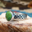 Sterling silver ring with Sonoran gold turquoise set in a round bezel and basket stamps along the band.