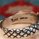 Close-up of the artisan's stamped signature.