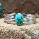 Sterling silver cuff bracelet with Sonoran gold turquoise set in the oval bezel and seven strands of silver making up the band.