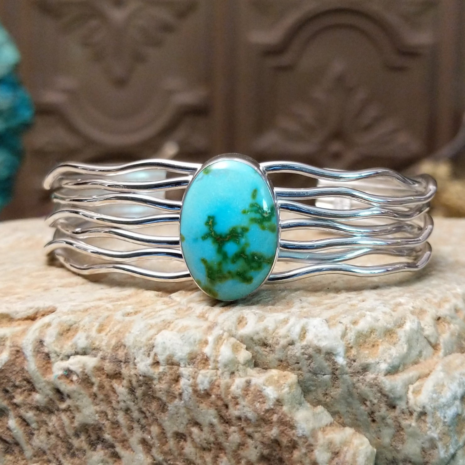 Sterling silver cuff bracelet with Sonoran gold turquoise set in the oval bezel and seven strands of silver making up the band.