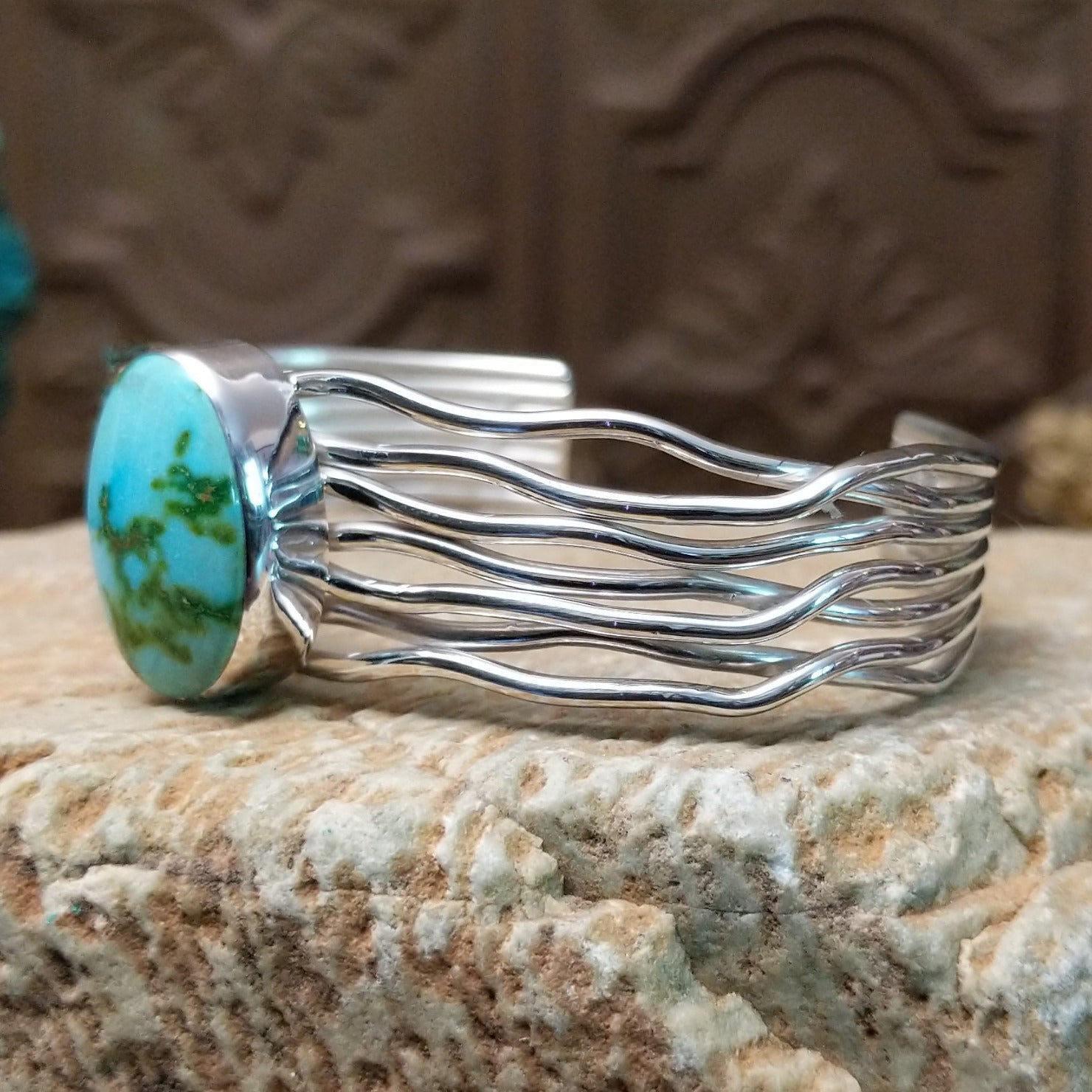 Sterling silver cuff bracelet with Sonoran gold turquoise set in the oval bezel and seven strands of silver making up the band.
