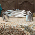 Sterling silver cuff bracelet with Sonoran gold turquoise set in the oval bezel and seven strands of silver making up the band.