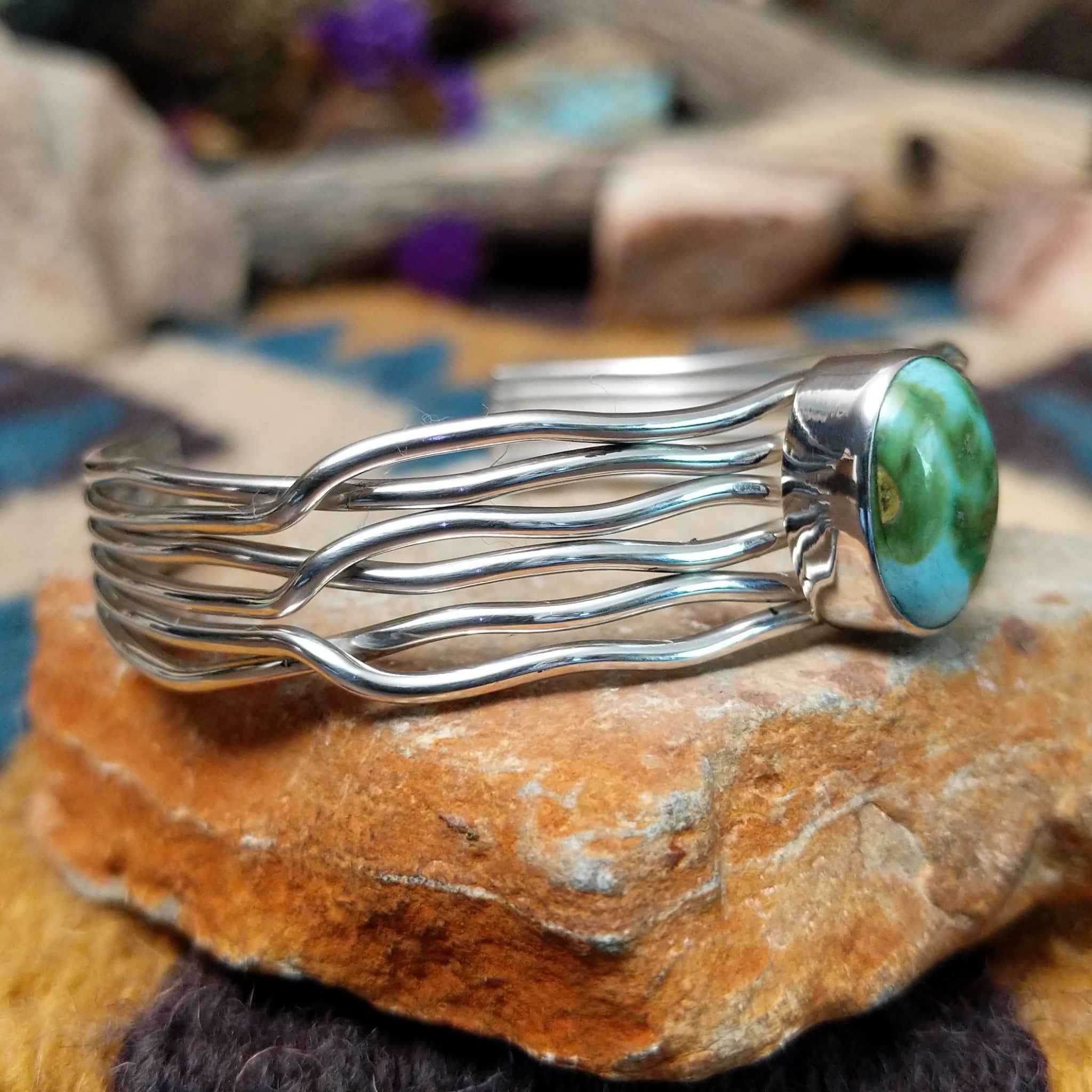 Handcrafted Navajo sterling silver five-strand cuff by Murphy Platero featuring an oval Sonoran Gold turquoise cabochon in a flowing open-wire design; side view.