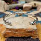 Handcrafted sterling silver twisted cuff by Raymond Coriz featuring an oval Sonoran Gold turquoise cabochon with vibrant blue, green, and natural golden matrix; underside view.