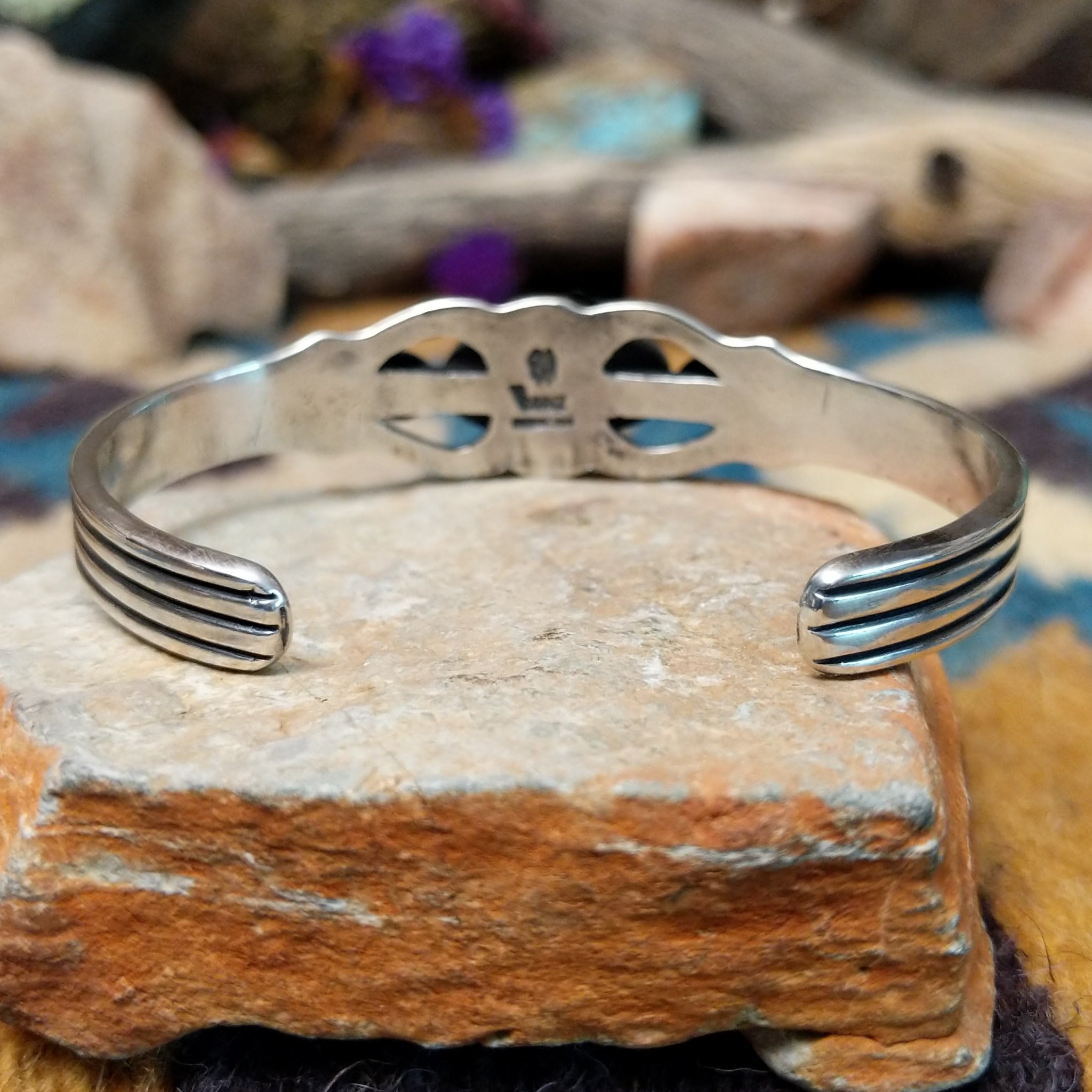 Handcrafted Navajo sterling silver cuff by Raymond Coriz featuring an oval Sonoran Mountain turquoise cabochon with polished silver bead accents, openwork scroll detailing, and a triple-split cuff design; underside view.