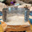 Handcrafted Navajo sterling silver cuff by Murphy Platero featuring a rectangular Sonoran Mountain turquoise cabochon with a twisted rope bezel, repoussé conchos, hand-stamped details, and polished silver accents; underside view.