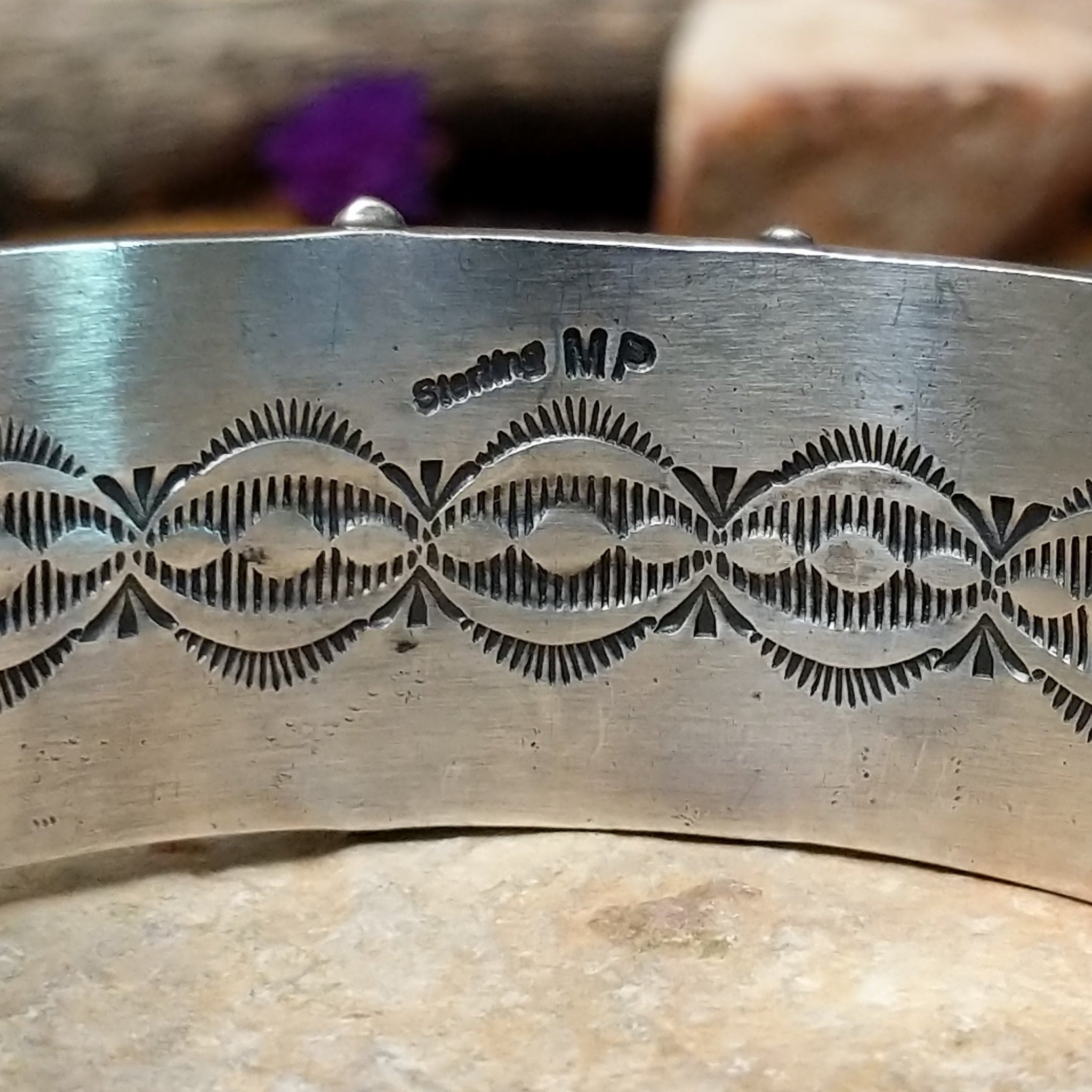 Handcrafted Navajo sterling silver cuff by Murphy Platero featuring a rectangular Sonoran Mountain turquoise cabochon with a twisted rope bezel, repoussé conchos, hand-stamped details, and polished silver accents; artisan and Sterling Silver stamp.
