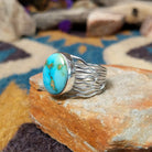 Sterling silver Sonoran Mountain Turquoise ring by Angela Martin with an oval sky-blue gemstone and natural golden matrix; side view.