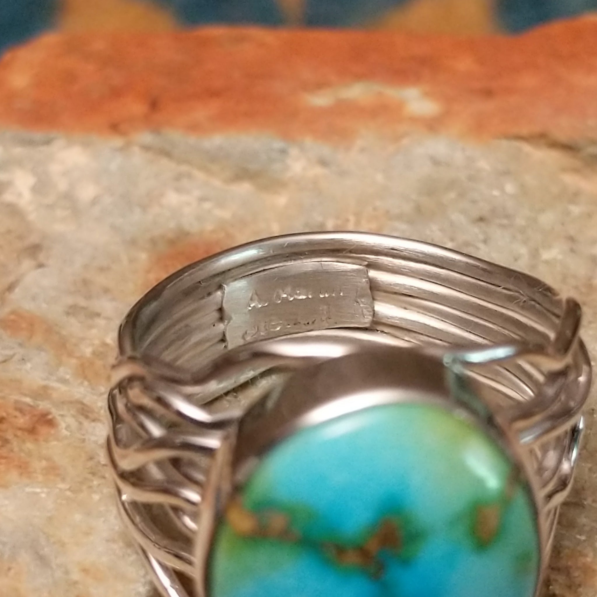 Sterling silver Sonoran Mountain Turquoise ring by Angela Martin with an oval sky-blue gemstone and natural golden matrix; artisan and Sterling Silver stamp.